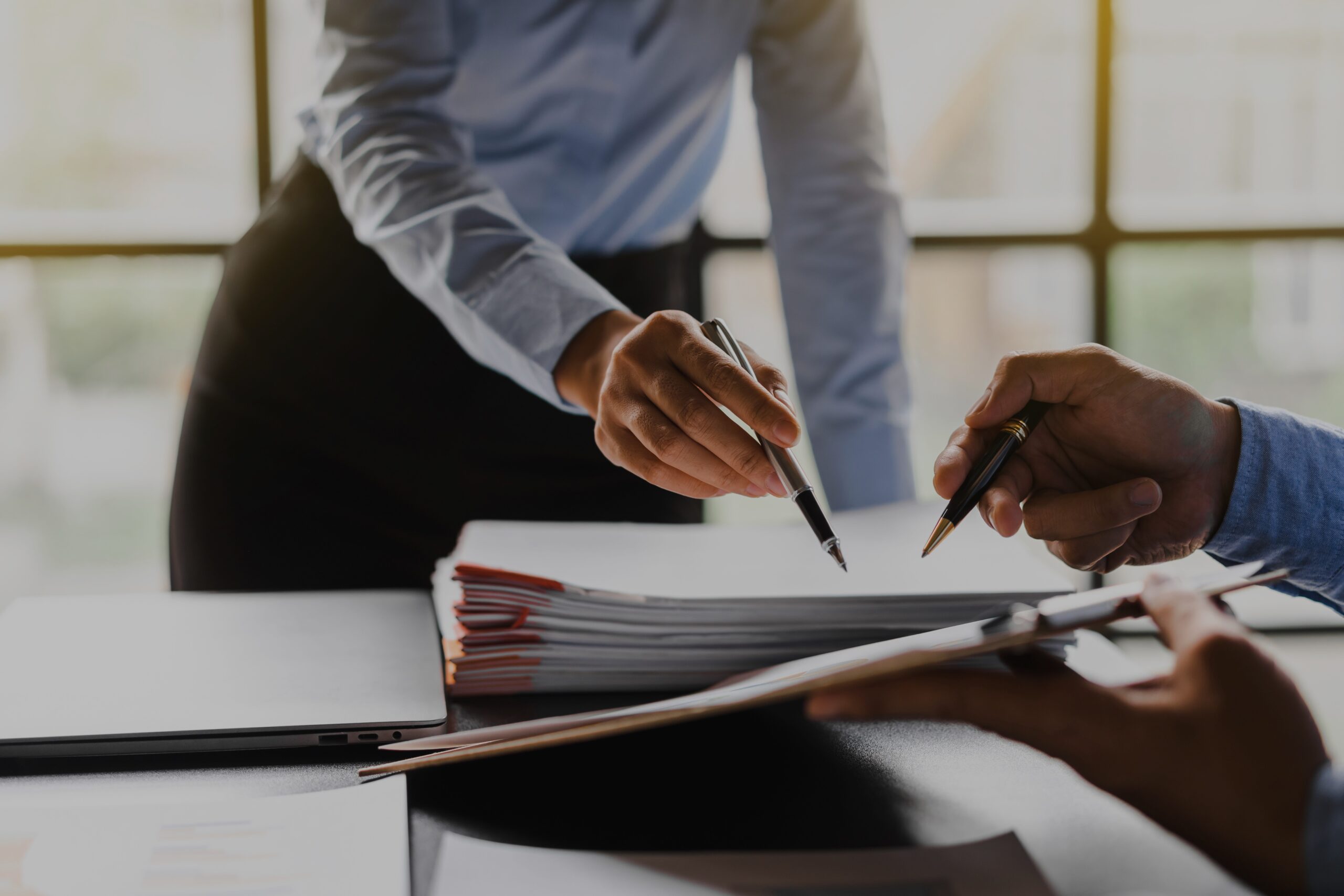 Man and women working in office and handling paperwork
